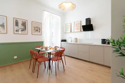 a kitchen and dining room with a table and chairs at Maison Bianchi - Downtown Nice Pertinax in Nice