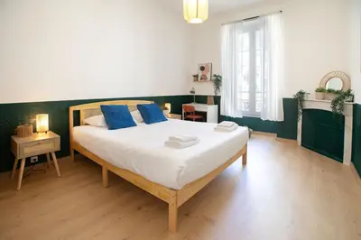 a bedroom with a large bed with blue pillows at Maison Bianchi - Downtown Nice Pertinax in Nice