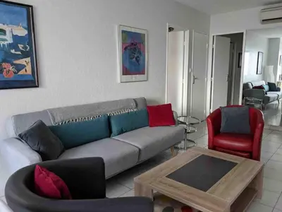 a living room with a couch and a table at Spacious 2 BR 1 block from beaches - and the TRAM in Nice