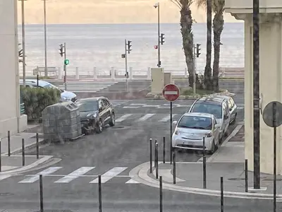 two cars parked in a parking lot next to the beach at Spacious 2 BR 1 block from beaches - and the TRAM in Nice