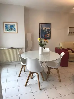 a white table and chairs in a living room at Spacious 2 BR 1 block from beaches - and the TRAM in Nice