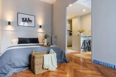 a bedroom with a large bed with a mirror at Appartement moderne proche mer et transports in Nice