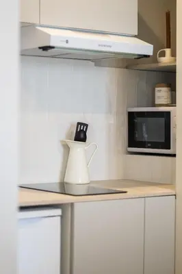 a white pitcher on a counter in a kitchen at Appartement moderne proche mer et transports in Nice