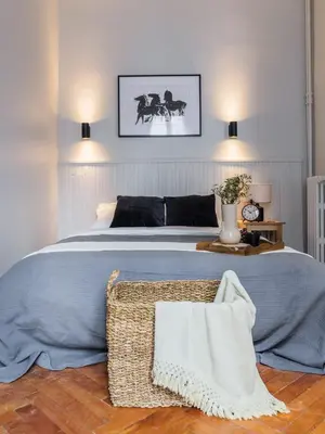 a bedroom with a large bed with a basket on the floor at Appartement moderne proche mer et transports in Nice