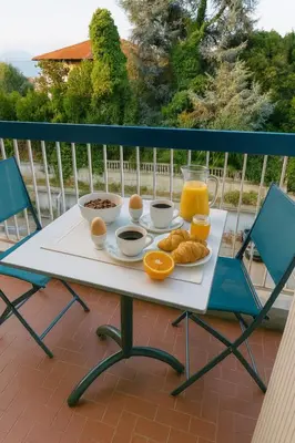 a tray of breakfast food on a table on a balcony at Studio proche de la mer avec parking Cagnes-sur-Mer in Cagnes-sur-Mer