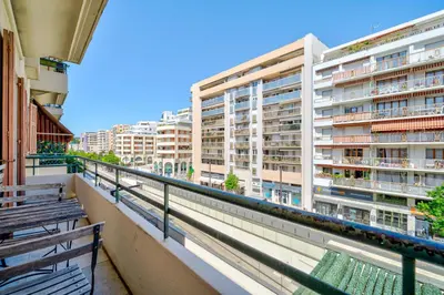 a balcony with two benches and a building at Studio moderne proche mer - Balcon et Climatisé in Nice