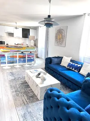 a living room with a blue couch and a table at La vie est belle - T2 - Coeur de Nice in Nice