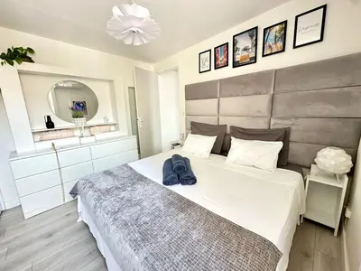 a bedroom with a large bed with a hat on it at La vie est belle - T2 - Coeur de Nice in Nice