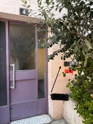 a purple door with a sign in front of it at La vie est belle - T2 - Coeur de Nice in Nice