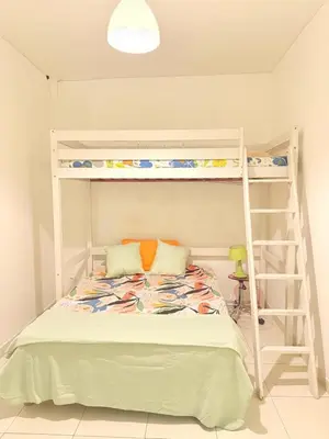 a bedroom with two bunk beds and a ladder at 3 pièces près du Port de Nice in Nice