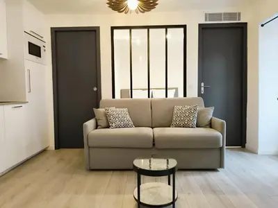 a living room with a couch and a table at Seytour Central Place in Nice