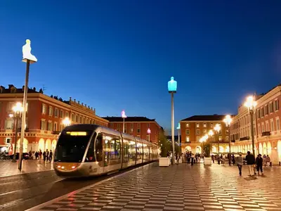 a train on a street in a city at night at Seytour Central Place in Nice