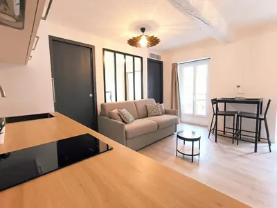 a living room with a couch and a table at Seytour Central Place in Nice