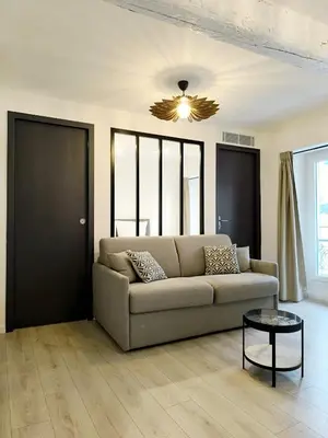 a living room with a couch and a table at Seytour Central Place in Nice