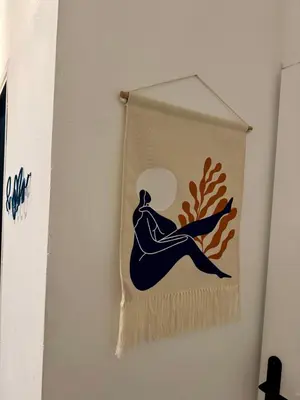 a towel hanging on a wall with a person on it at Joli 2 pièces avec terrasse en centre ville in Nice