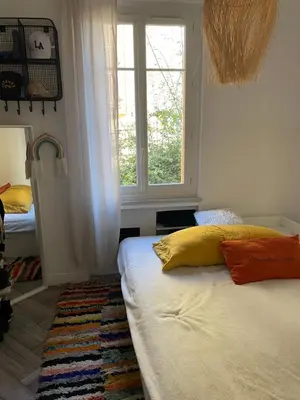 a bedroom with a bed and a window at Palais Libération 3 pièces in Nice