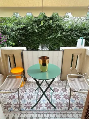 a table and two chairs on a patio at Palais Libération 3 pièces in Nice