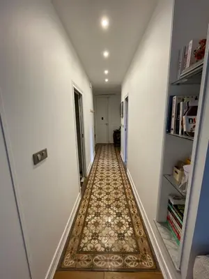 a hallway with a tile floor in a house at Palais Libération 3 pièces in Nice