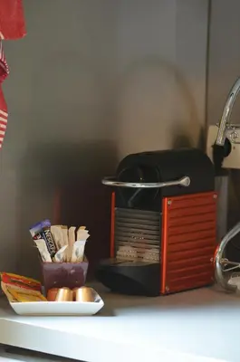 a kitchen counter with a toaster and a plate of food at Rivoli Center Terrasse Clim Parking in Nice