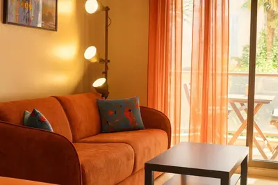 a living room with a couch and a table at Rivoli Center Terrasse Clim Parking in Nice