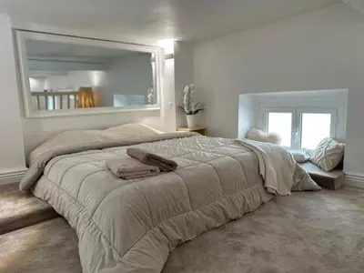 a bedroom with a large bed with two towels on it at Gaya in Nice