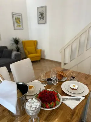 a wooden table with plates of food and wine glasses at Gaya in Nice