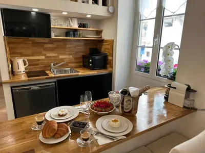 a kitchen with a table with plates of food on it at Gaya in Nice