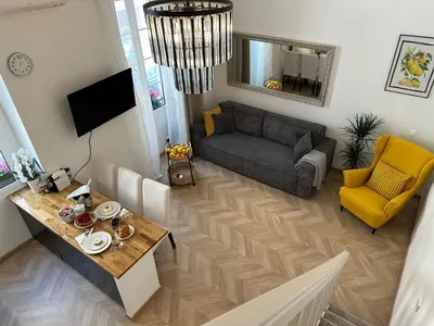 a living room with a couch and a table at Gaya in Nice