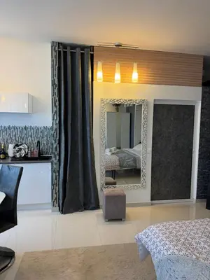 a bedroom with a mirror and a bed in it at Maison Ariana in Nice