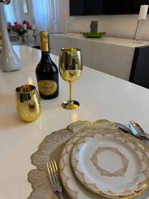 a bottle of wine and a plate and a wine glass at Maison Ariana in Nice