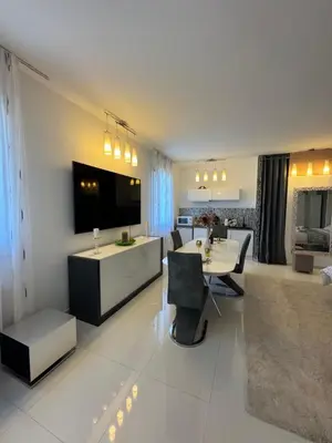 a living room with a table and a dining room at Maison Ariana in Nice