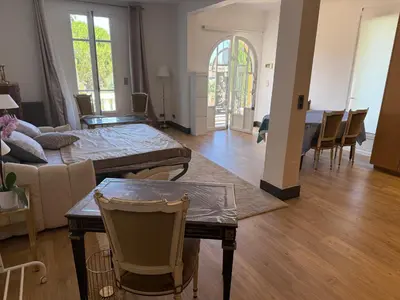 a living room with a couch and a table at Magnifique studio entier avec terrasse Saint Jean Cap Ferrat in Saint-Jean-Cap-Ferrat