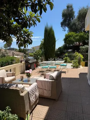 a patio with couches and tables and a grill at Magnifique studio entier avec terrasse Saint Jean Cap Ferrat in Saint-Jean-Cap-Ferrat