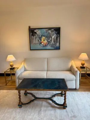 a living room with a couch and a coffee table at Magnifique studio entier avec terrasse Saint Jean Cap Ferrat in Saint-Jean-Cap-Ferrat