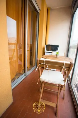 a table and chair in a room with a window at l'Or dans la Mer Partner in Nice