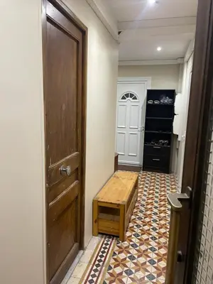 a hallway with a door and a stool in a room at Studio cosy - Nice Mont Boron in Nice