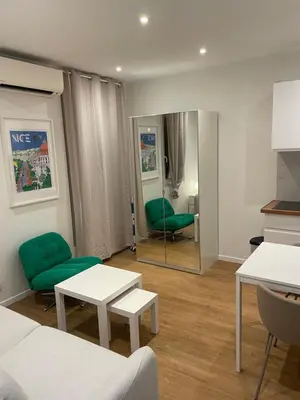 a living room with green chairs and a mirror at Studio cosy - Nice Mont Boron in Nice