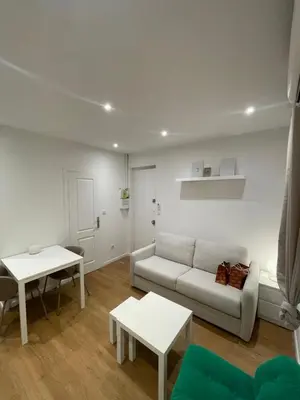 a living room with a couch and a table at Studio cosy - Nice Mont Boron in Nice