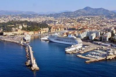 a large cruise ship docked in a harbor at Cosy studio le port in Nice