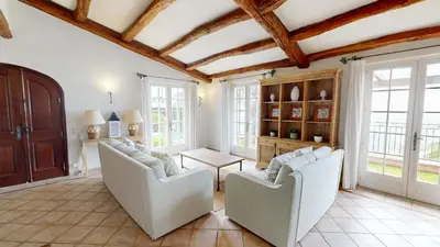 a living room with two white chairs and a table at Villa Ezea - vue mer et charme in Èze