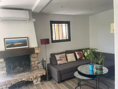 a living room with a couch and a fireplace at La Petite Maison des Baous in Saint-Jeannet