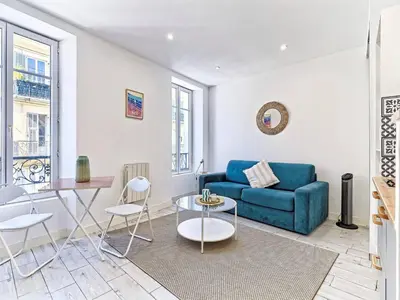 a living room with a blue couch and a table at Studio Hyper Centre - WIFI - Central in Nice