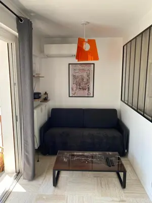 a living room with a couch and a coffee table at Vacances à la mer in Cagnes-sur-Mer