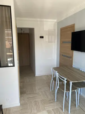 a room with a table and chairs and a door at Vacances à la mer in Cagnes-sur-Mer