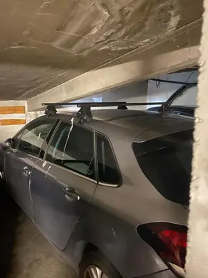 a car parked in a garage with a surfboard on the roof at Vacances à la mer in Cagnes-sur-Mer