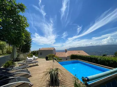 a backyard with a swimming pool and lounge chairs at APPART DANS VILLA AVEC GRANDE TERRASSE PRIVATIVe in Aspremont