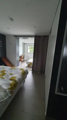 a bedroom with a large bed and a window at APPART DANS VILLA AVEC GRANDE TERRASSE PRIVATIVe in Aspremont