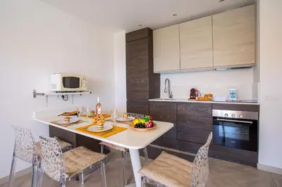 a kitchen with a table with a bowl of fruit on it at VISTA MARE AP4459 By Riviera Holiday Home in Villefranche-sur-Mer