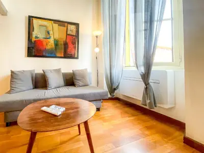 a living room with a couch and a table at Place Massena 4 Pers AC WiFi in Nice