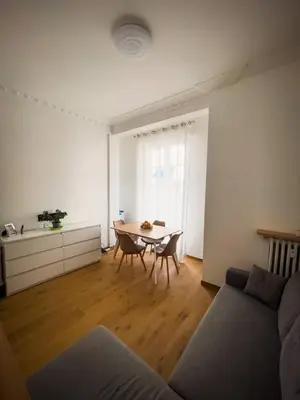 a living room with a table and a couch at Typical Nice neighborhood 15 min from beach in Nice